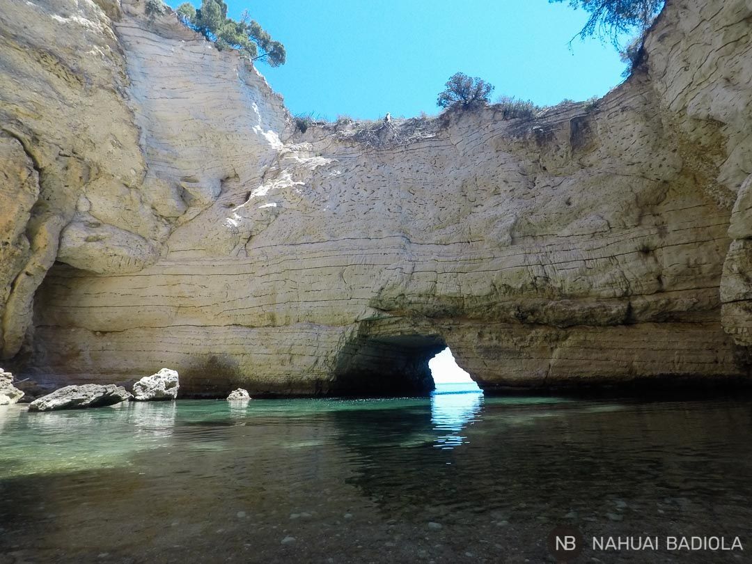 Large cave without a roof near Campi beach, Italy.
